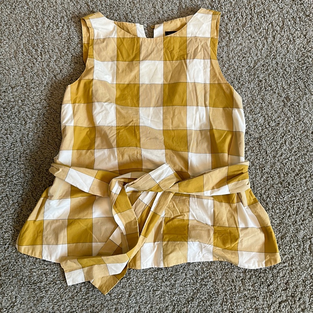 Tie front, sleeveless plaid top.